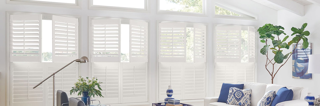 White Polywood shutters in a large blue decorated sun room